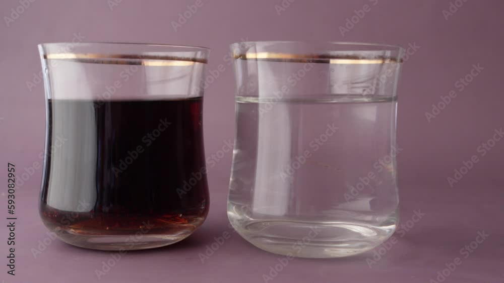 comparing soft drinks with glass of water on table comparing soft drinks with glass of water on table
