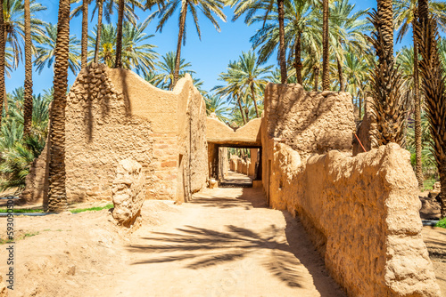 Al Ula ruined old town street with palms along the road, Saudi Arabia photo