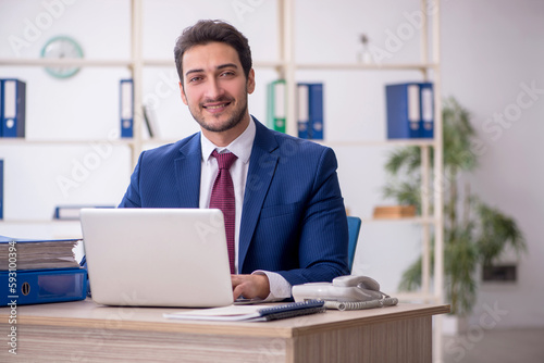 Young male employee and too much work in the office