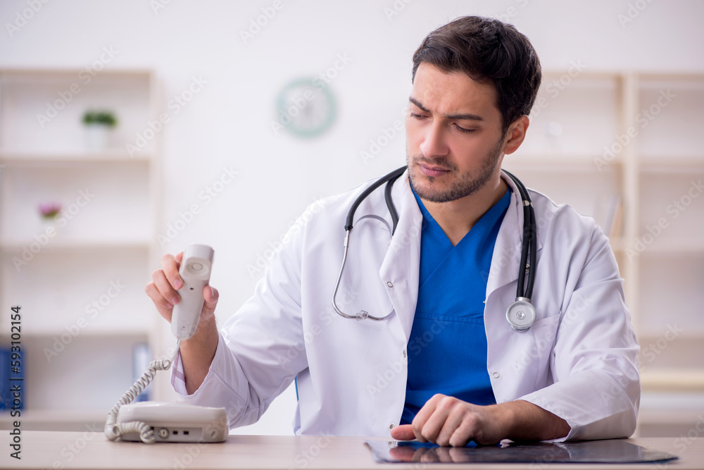 Young male doctor working in the clinic Young male doctor working in the clinic