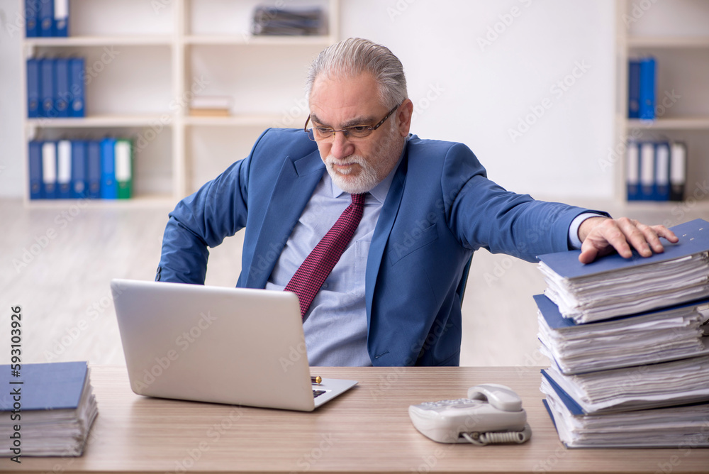 Old male employee and too much work at workplace Old male employee and too much work at workplace