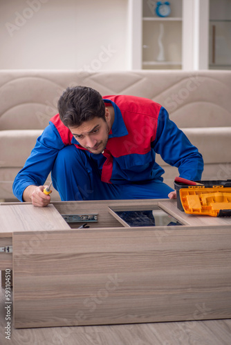 Young male carpenter working at home