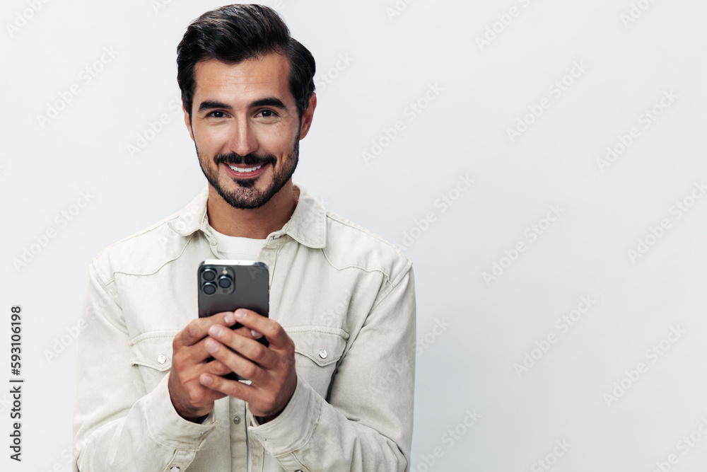 Close-up portrait man holding a phone smile typing a message, chatting online freelance work on a white isolated background, fashionable clothing style, copy space, space for text Close-up portrait man holding a phone smile typing a message, chatting online freelance work on a white isolated background, fashionable clothing style, copy space, space for text