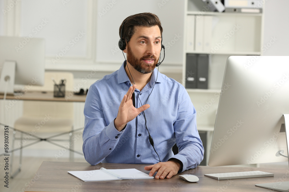 Hotline operator with headset working in office Hotline operator with headset working in office