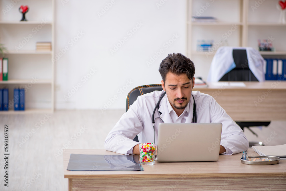 Young male doctor working in the clinic Young male doctor working in the clinic