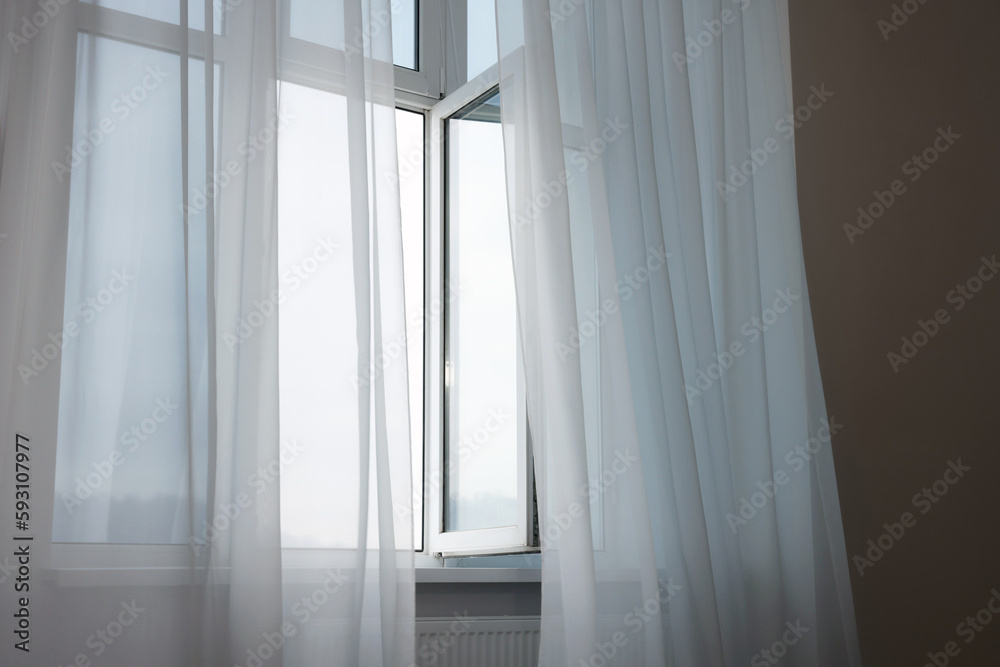 Fototapeta premium Open window and elegant white curtains indoors. Interior design