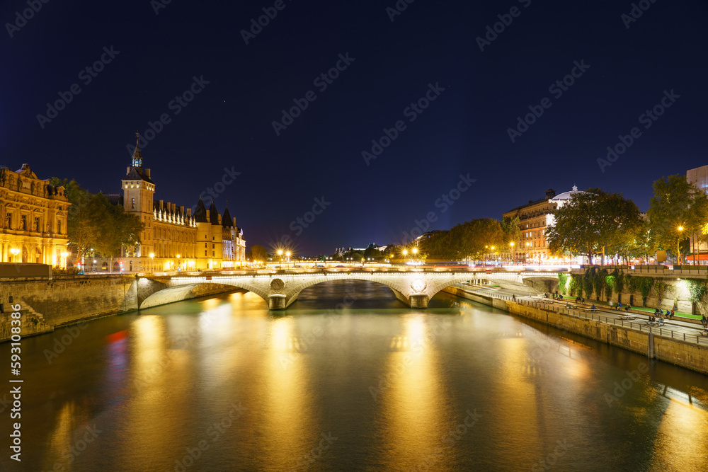 Pont Change bridge and Conciergerie at night in Paris. France