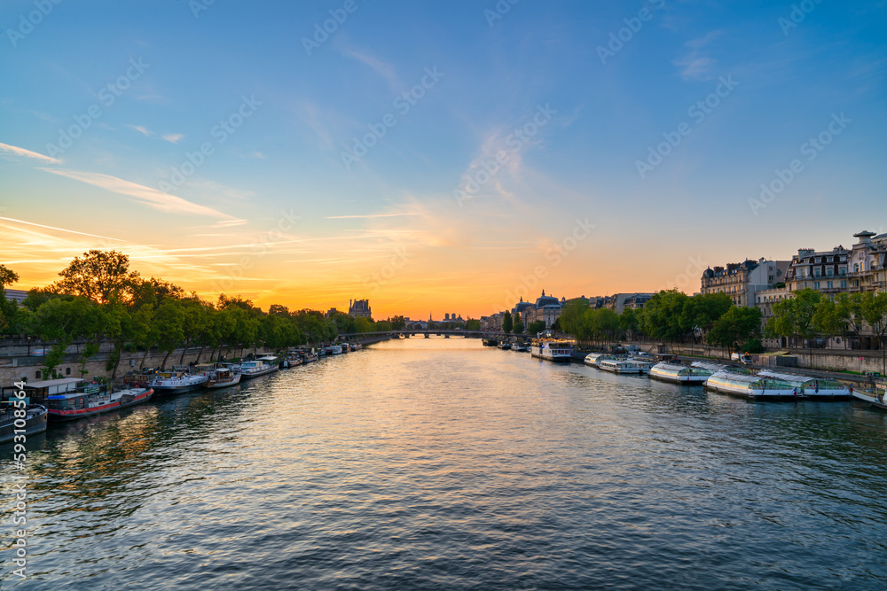 Seine river at sunrise overlooking Passerelle Leopold Sedar Senghor footbridge and rooftop of Notre  Dame cathedral in Paris. France