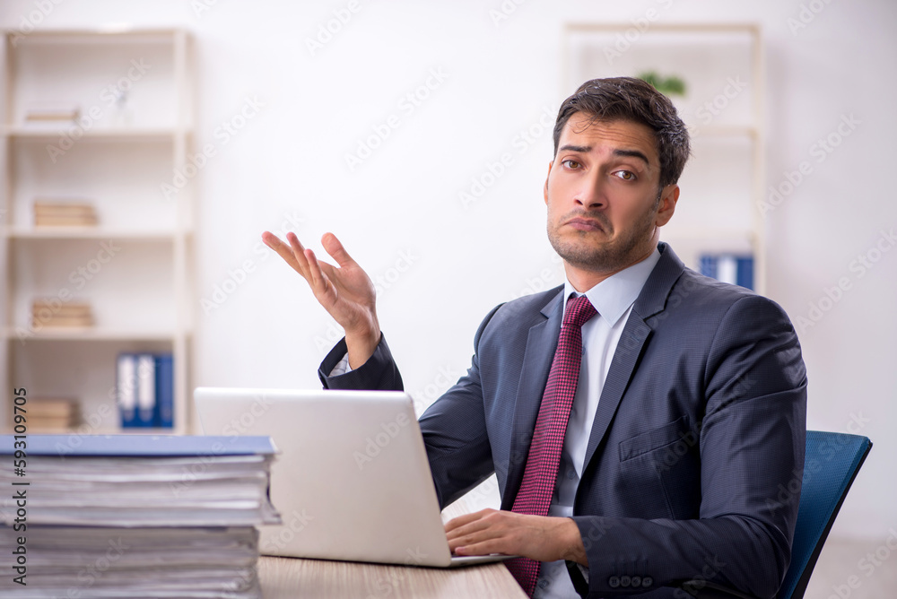 Young male employee working in the office Young male employee working in the office