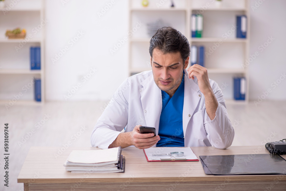 Young male doctor in telemedicine concept Young male doctor in telemedicine concept