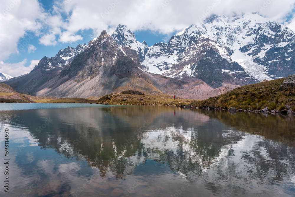 Nevado de Ausangate, Cuzco, Peru, Photo of the snow-capped mountain Ausangate at a beautiful day with a blue sky, with alpacas and puddles of water.