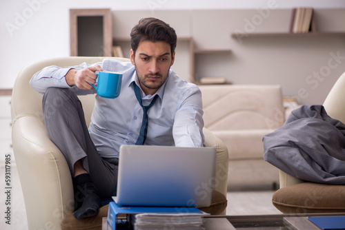 Young male employee working from home