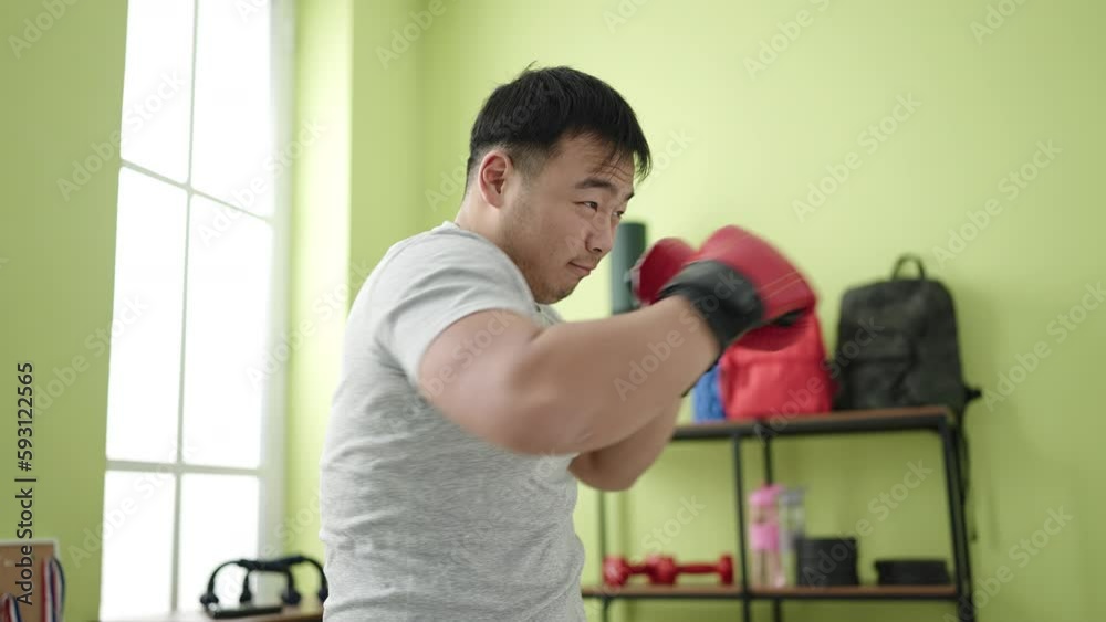 Young chinese man boxing at sport center Young chinese man boxing at sport center