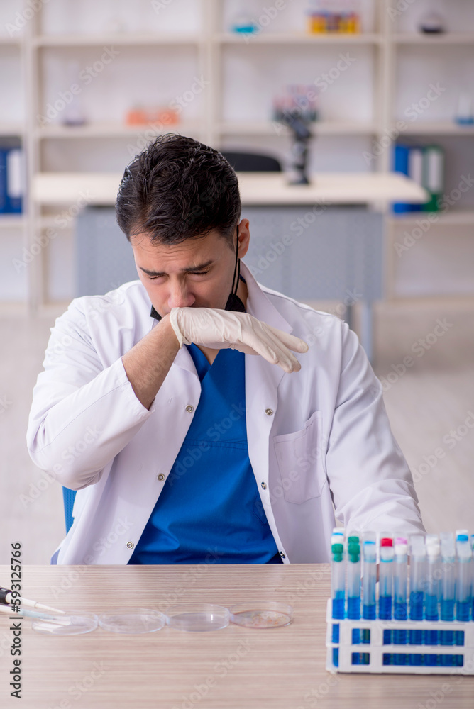 Young male chemist working at the lab Young male chemist working at the lab