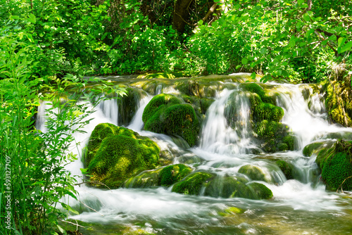 Beautiful Waterfall background in sunny summer day. Beautiful Waterfall In Krka National Park - Croatia, Europe. Krka river waterfalls in the Krka National Park