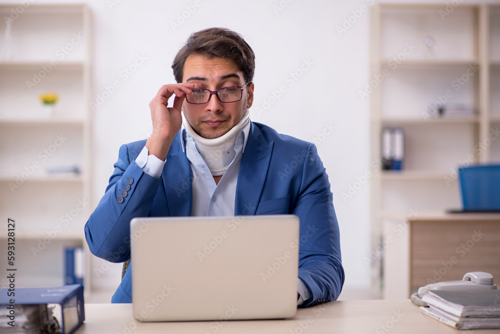 Young male employee after car accident at workplace