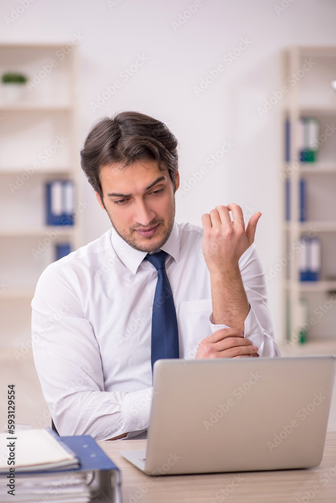 Young male employee working in the office Young male employee working in the office