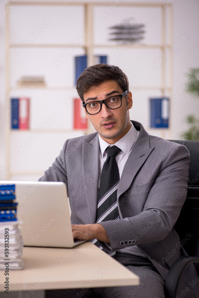 Young male employee working in the office Young male employee working in the office