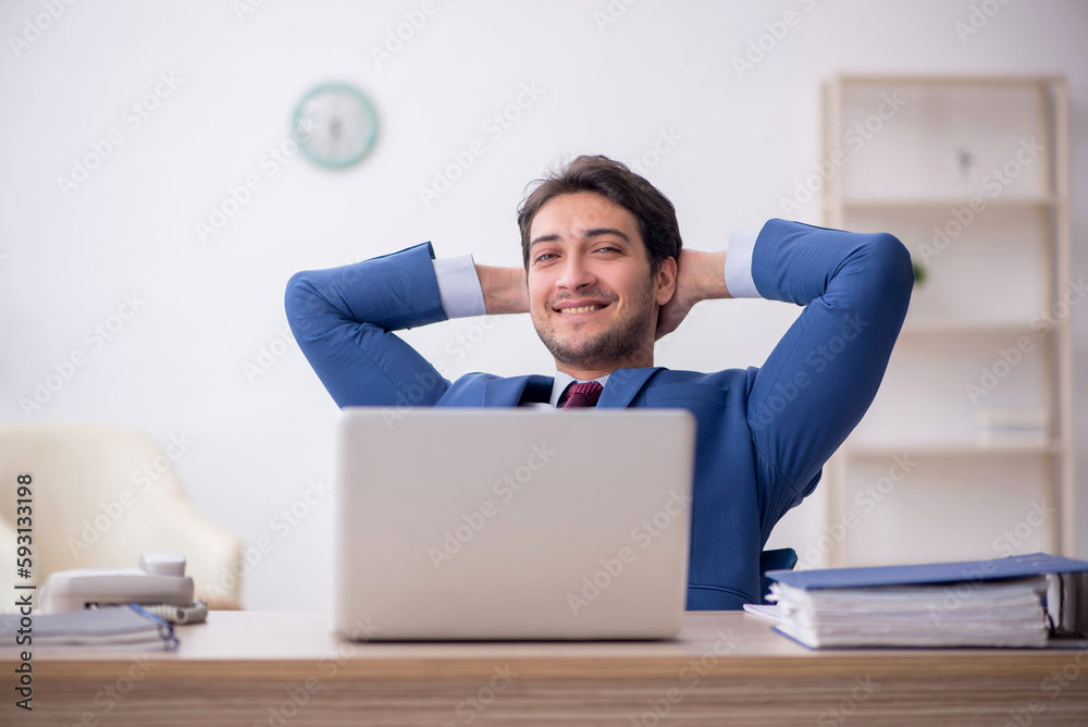 Young male employee working in the office Young male employee working in the office