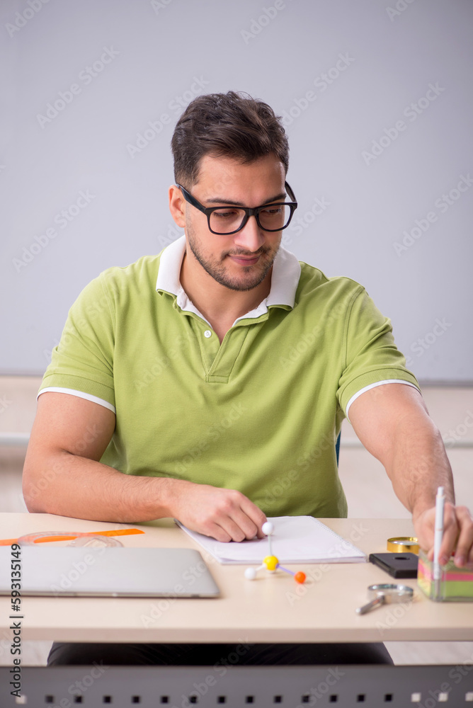 Young male student preparing for exams in the classroom Young male student preparing for exams in the classroom
