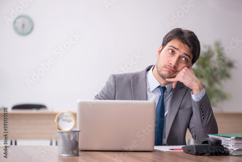 Young male employee working in the office