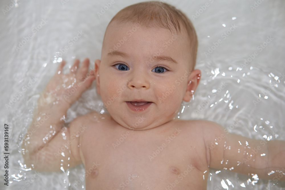 Portrait of a baby boy with blue eyes in the bath. Portrait of a baby boy with blue eyes in the bath.