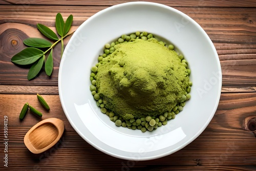 moringa powder isolated on wooden background. healthy tea flat lay