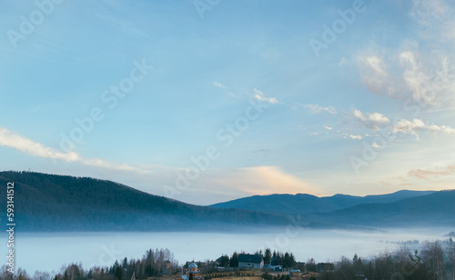 Thick fog in the foothills of the Carpathian Mountains in the autumn morning © Денис Лаврентьев