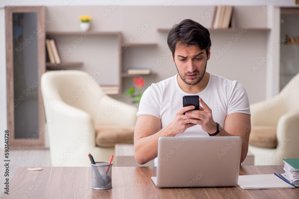 Young male employee working from home during pandemic Young male employee working from home during pandemic