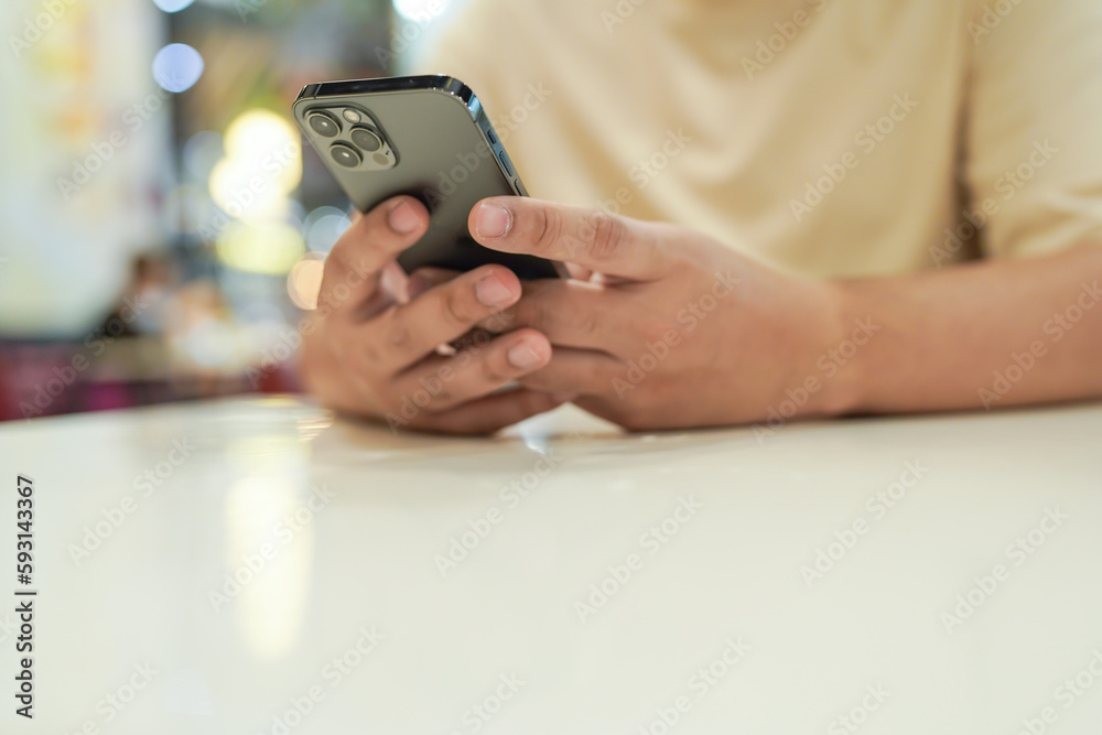 Relaxed young asian man using smart phone spending time checking news social media. Relaxed young asian man using smart phone spending time checking news social media.