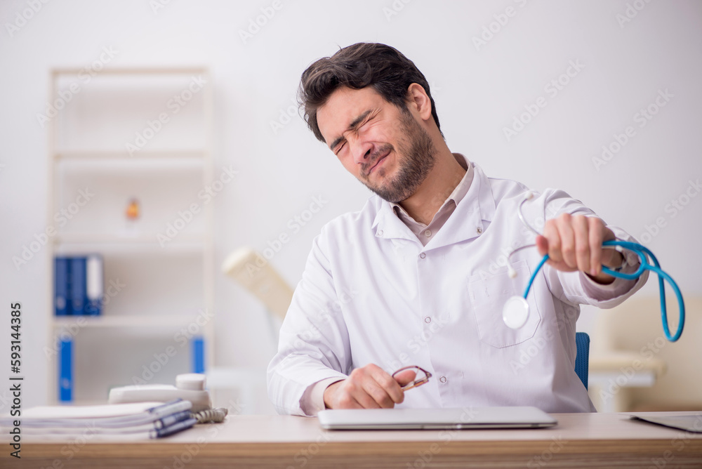 Young male doctor working in the clinic Young male doctor working in the clinic