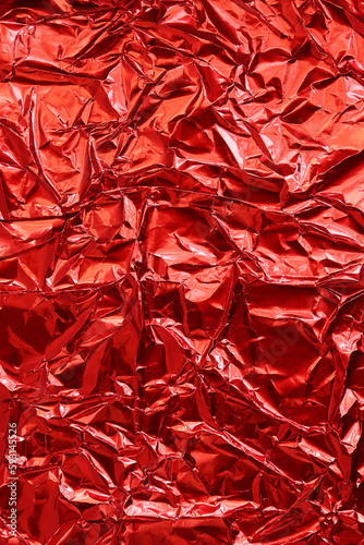 red shiny crinkle aluminum foil as background