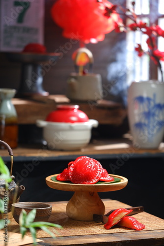 Red glutinous cake or kue ku in a wooden tier photo