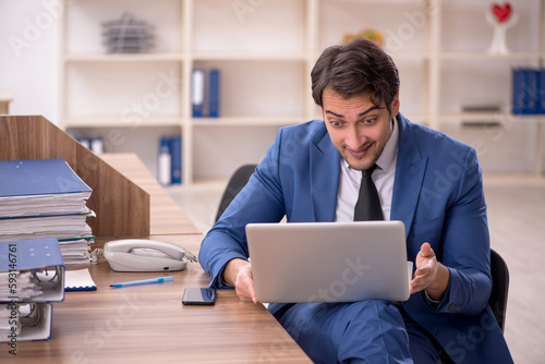 Young male employee working in the office