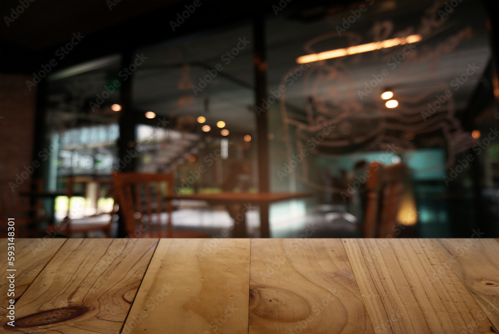 Empty wooden table in front of abstract blurred background of restaurant . can be used for display or montage your products.Mock up for display of counter.