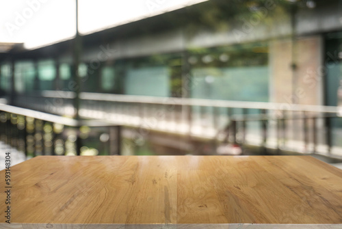 Empty wooden table in front of abstract blurred background of restaurant . can be used for display or montage your products.Mock up for display of counter.