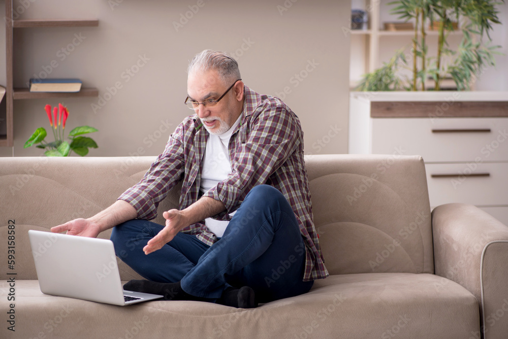 Old man working from home during pandemic