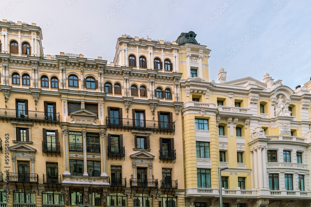 Historic old buildings in the shopping street Gran Via in Madrid