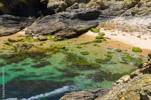 Atlantic ocean coastline with rocks, light sand and turquoise water