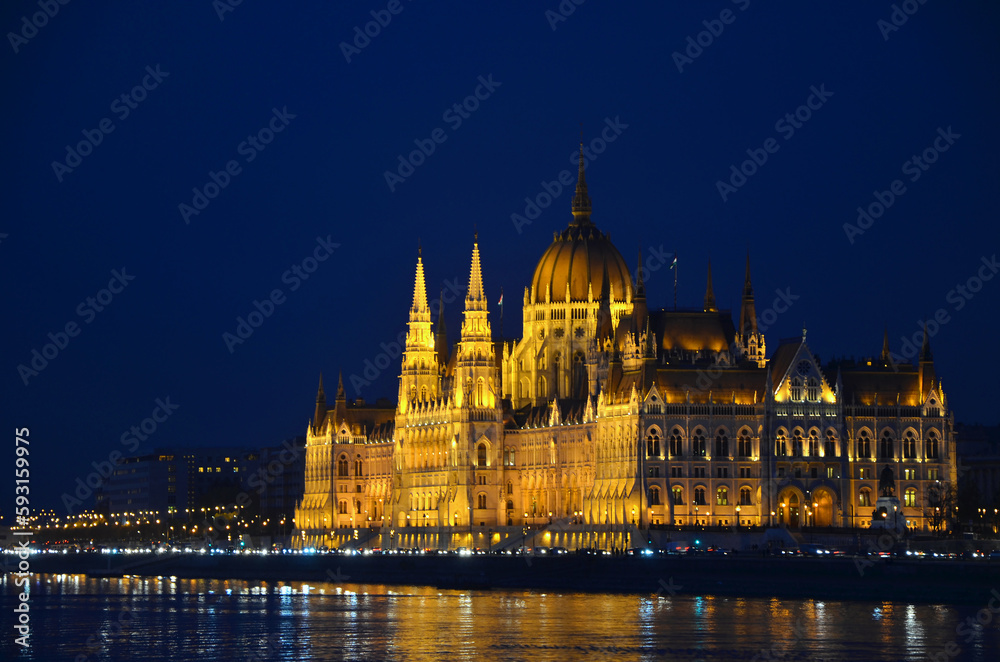Parliament building in Budapest on embankment of Danube at night.