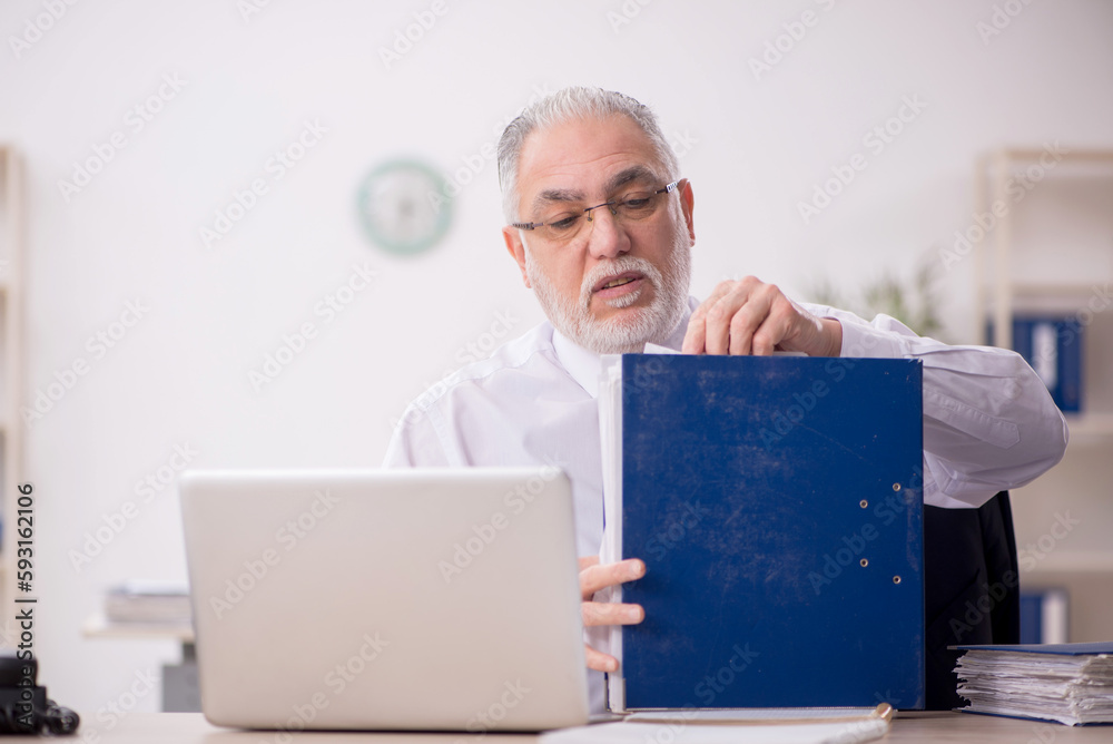 Old male employee and too much work in the office Old male employee and too much work in the office