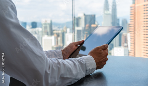 Canvas Print Businessman hands with tablet, online network and Kuala Lumpur skyscrapers