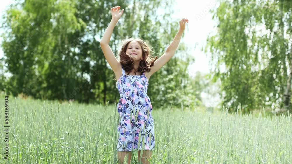 Cute teenage girl happily dancing and jumping in a summer park Cute teenage girl happily dancing and jumping in a summer park