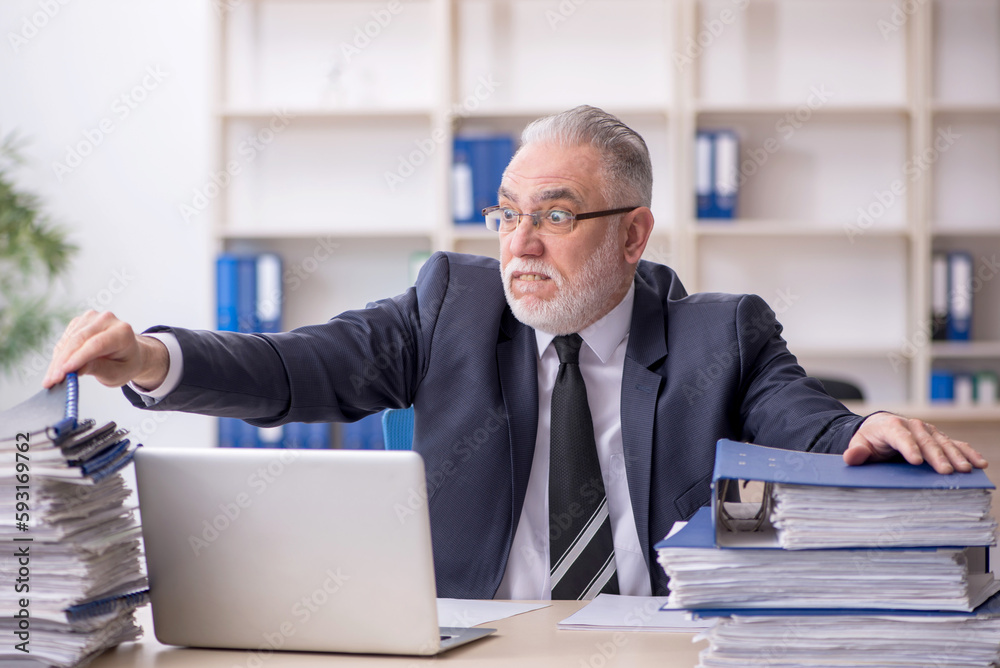 Old male employee and too much work at workplace Old male employee and too much work at workplace
