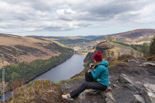 Hiker woman drinking traditional Argentinian mate in Glendalough photo