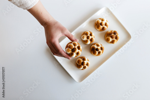 lemon tarts are laid out on a tray with caramelized cream photo