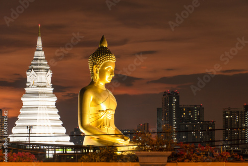 View of seated buddha in Wat Paknam Phasi Charoen temple at sunset photo