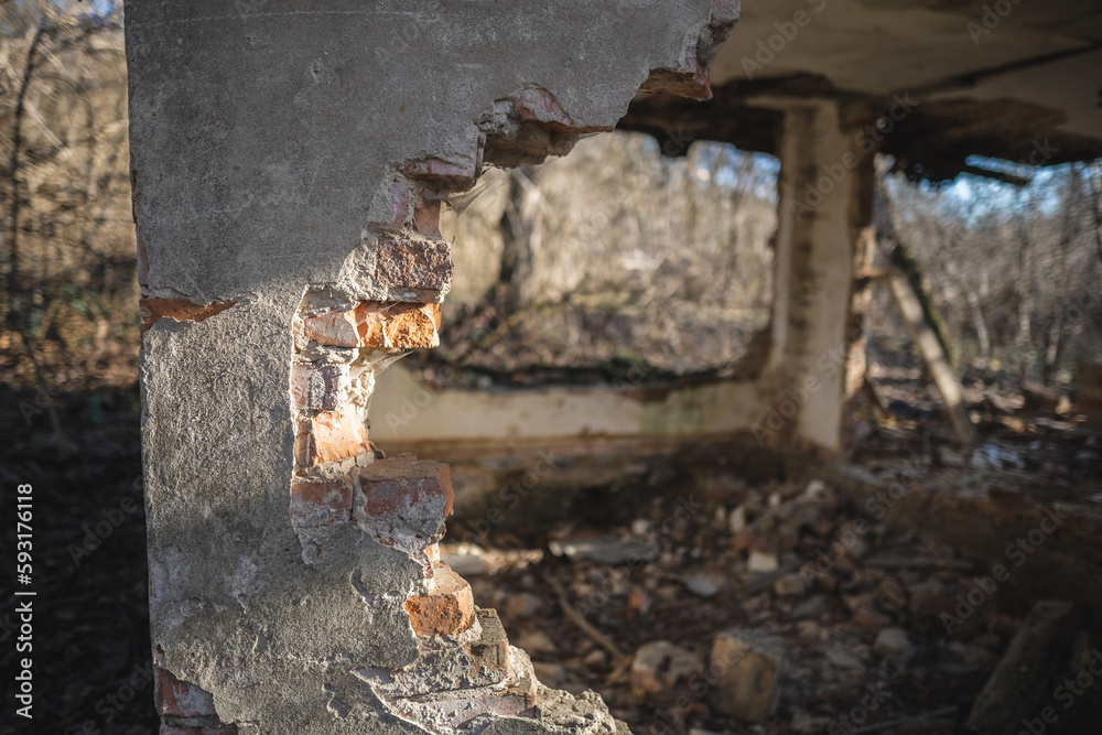 Fototapeta premium old ruined house, not suitable for living, fallen brick wall