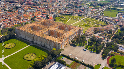 Aerial view of the Royal Palace of Caserta also known as Reggia di Caserta. It is a former royal residence with large gardens in Caserta, near Naples, Italy. The historic center of the city is nearby.