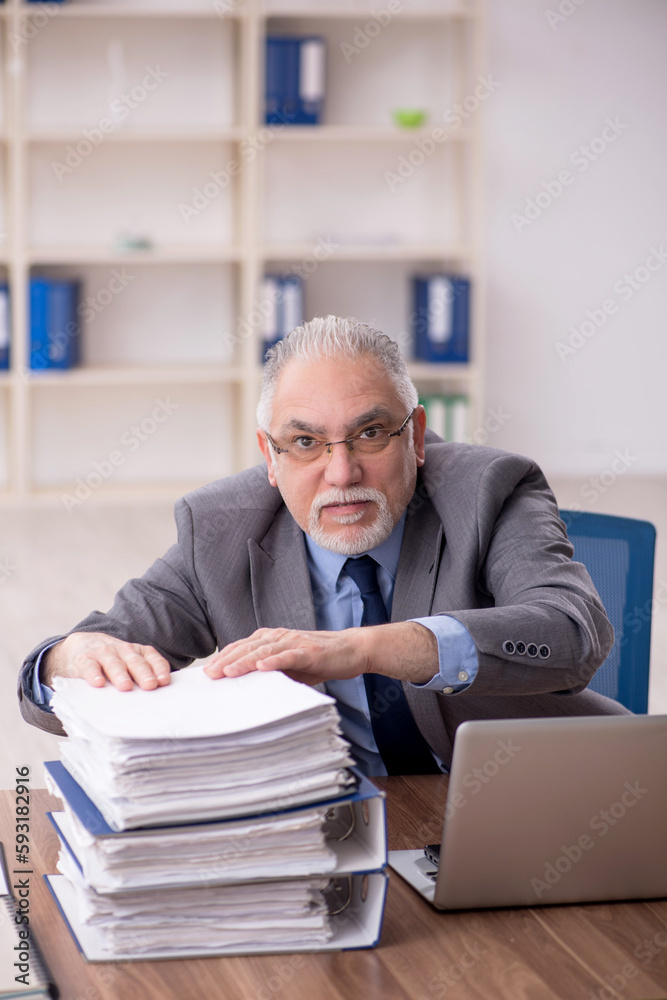 Old male employee wearing spacesuit in the office Old male employee wearing spacesuit in the office